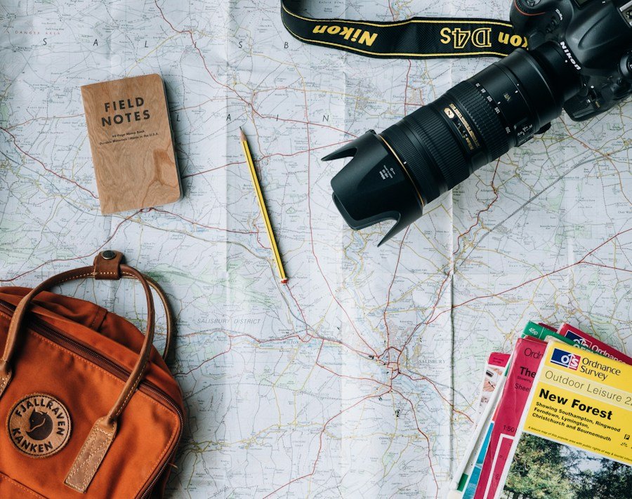 Camera, notebook and travel maps ready for an adventure